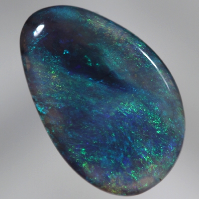 SOLID BLACK CRYSTAL OPAL Constant green and blue fire engulf a patch of black opal